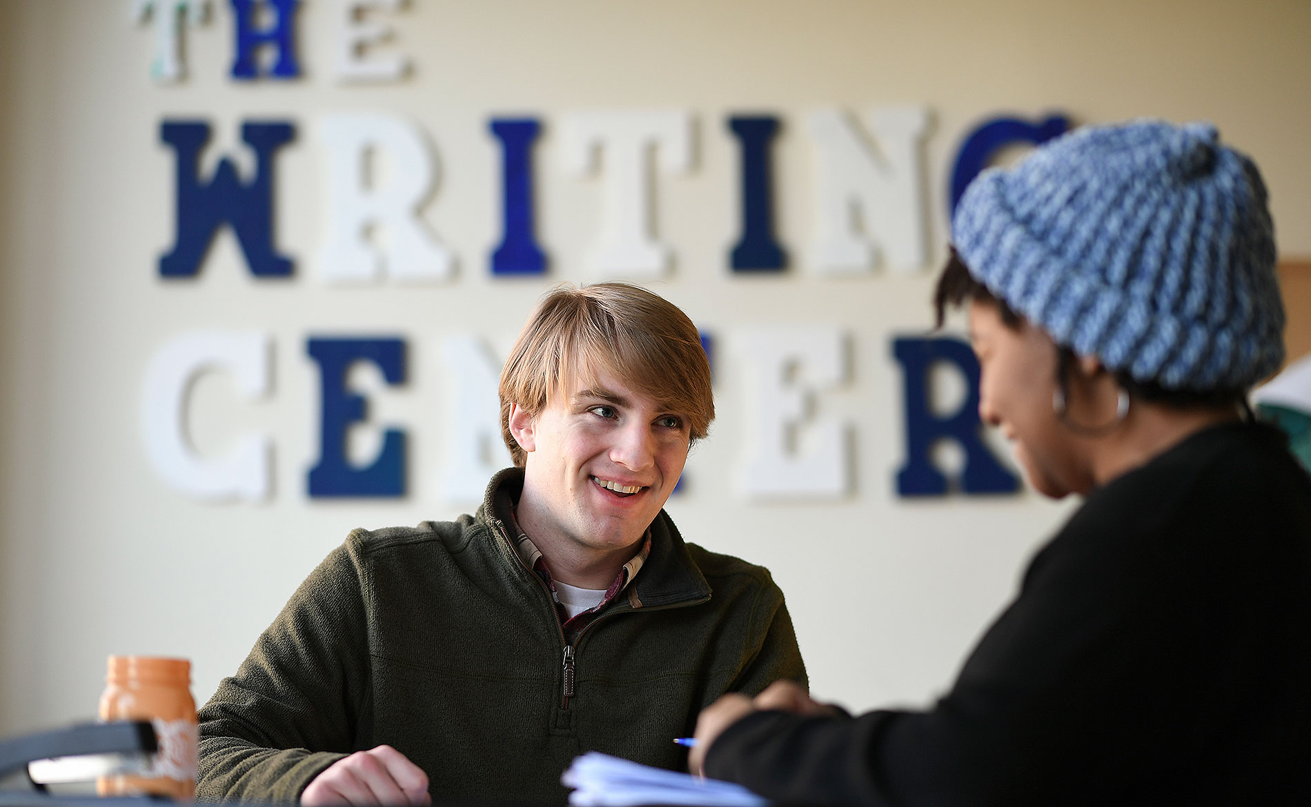 two students laughing in the writing center