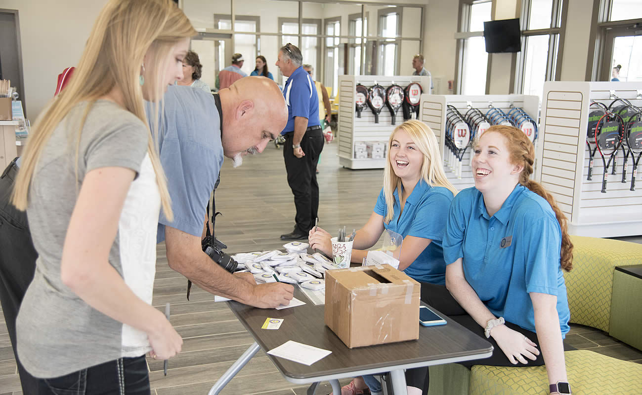 Students working in a tennis equipment shop