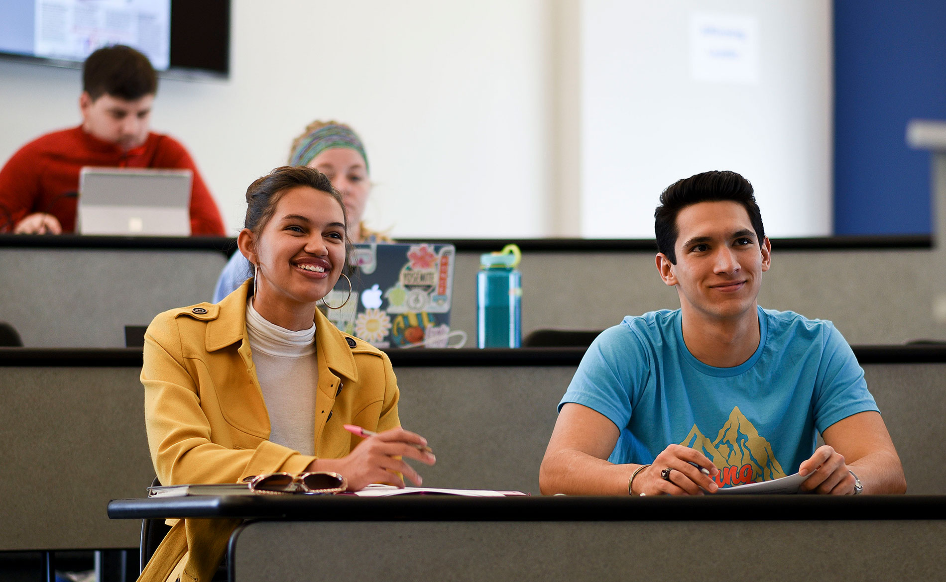 Students sitting in a class with stadium style seating