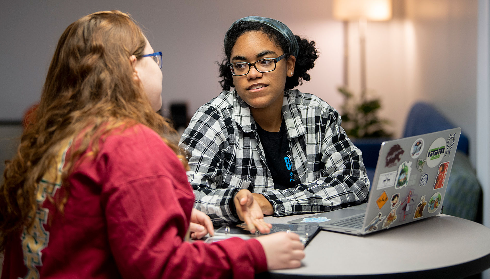 Students talking with a laptop