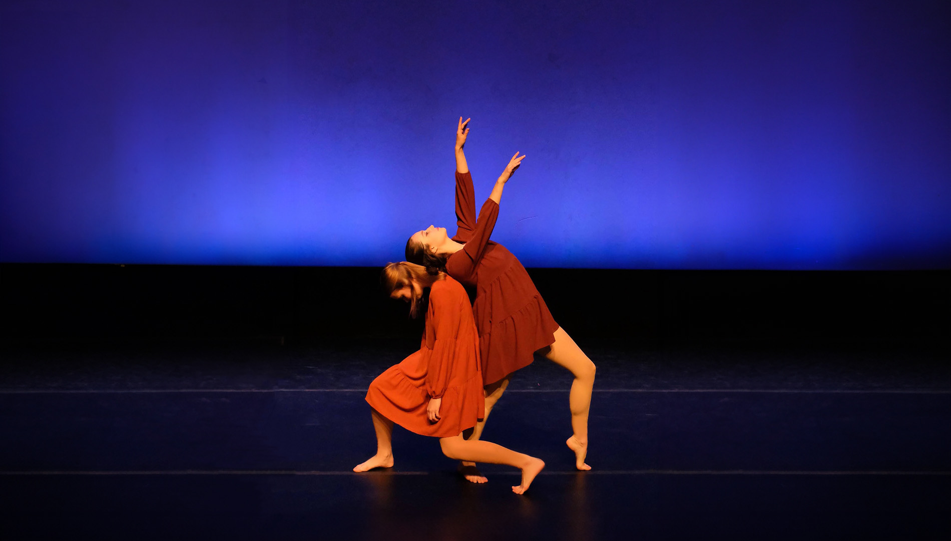 two girls dancing on stage